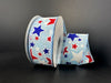 The 1.5X10Y Lt Blue Navy Red White Linen Glitter Stars Ribbon features red, white, and blue stars on a light blue background, elegantly coiled and perfect for adding sparkle and charm to any decor with its wired star pattern against a dark surface.