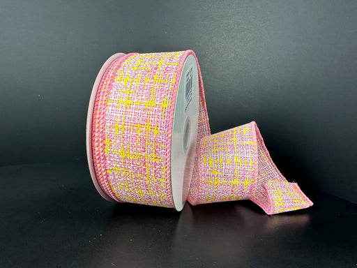 The 1.5X10Y Pink White Yellow Embellished Tweed Ribbon 41522-09-03 features a colorful pink, yellow, and white pattern on a black background with a textured woven appearance, partially unrolled to reveal its vibrant design.