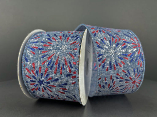 Displayed on a gray background are two rolls of the Denim Linen/Red-Blue-Silver Glitter Fireworks ribbon, model 42405-40-05. Measuring 2.5X10Y, these ribbons showcase red, white, and blue designs with a denim texture and glitter fireworks pattern, ideal for festive or patriotic events.