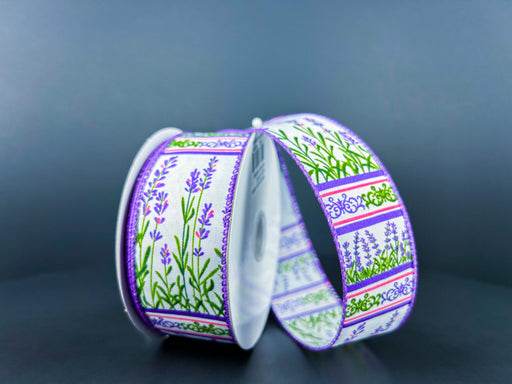 Two spools of the 1.5X10Y White Satin/Lavender Garden Ribbon feature decorative lavender and green floral patterns with purple and pink borders, elegantly contrasting against a dark gray backdrop.