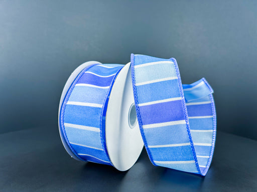 The 1.5X10Y White Satin/Lavender-Periwinkle-Blue Wide Stripes Ribbon, product code 42417-09-32, is shown against a dark background with alternating light and dark blue sections partially unrolled.