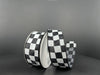 Two rolls of 1.5X10Y Black Satin/White Race Checks Ribbon (42437-09-21) are against a gray background: one upright, the other partially unrolled to display its black and white checkered pattern.