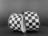 Two 2.5X10Y Black Satin/White Race Checks Ribbons 42437-40-21 are set against a dark background with the wired ribbons arranged diagonally, one slightly leaning against the other.