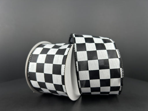 Two 2.5X10Y Black Satin/White Race Checks Ribbons 42437-40-21 are set against a dark background with the wired ribbons arranged diagonally, one slightly leaning against the other.