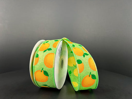 The Lime Linen/Oranges ribbon, 1.5 wide and 10 yards long (42448-09-09), displays a wired, green base with yellow oranges and lush green leaves, partially unrolled on a dark gray background.