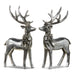 The 7 Set of Two Silver Deer with Bow Ornament (4312130) features metallic reindeer figures facing each other, adorned with neck bows, shiny reflective surfaces, and detailed antlers, creating a dazzling and festive holiday display.