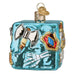 A light blue glass Dungeons and Dragons Gelatinous Old World Christmas Ornament 44230 featuring a skeleton hand, a silver battle axe, and a shield embedded in the surface.