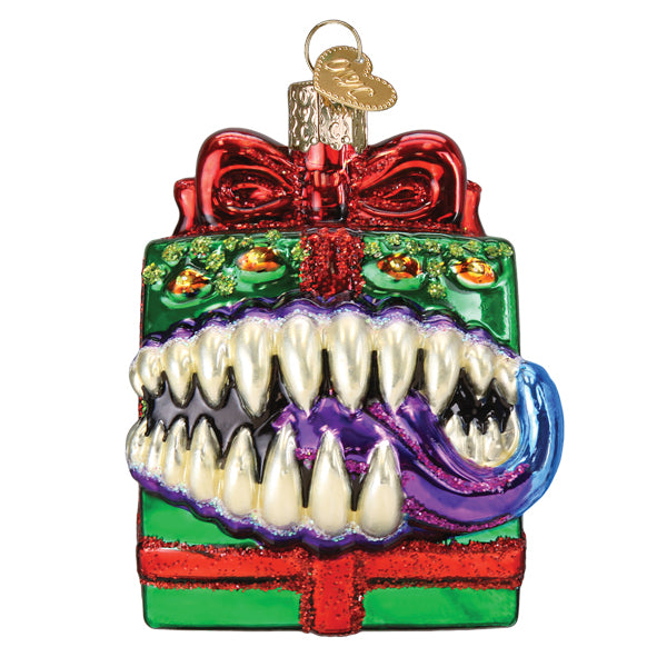 Dungeons and Dragons Holiday Mimic Old World Christmas Ornament 44232: a green gift box ornament with a red bow, featuring a snarling mimic with sharp teeth and a purple tongue emerging from the center.