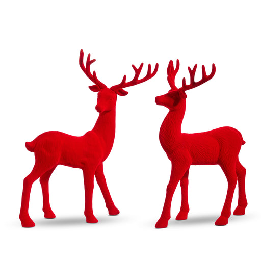Two 13" red flocked deer figurines with antlers stand facing each other on a white background, perfect accents from the All of the Trimmings Collection. Product: 13" Red Flocked Deer 4432754.