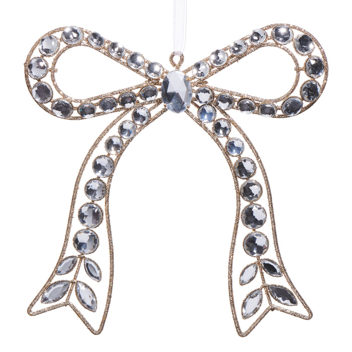 The 7.25" Clear Jeweled Bow Ornament 4513577 from the Holiday Rendezvous Collection features looped ends, hanging tails, sparkling clear gemstones, gold accents, and hangs by a white ribbon.