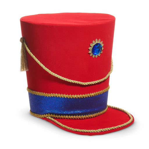 The 11.5" Nutcracker Hat Tree Topper 4516702 from the Christmas Shoppe Collection features a tall, bright red polyester hat with flat top, gold cord, blue glitter band, gold tassel, and a large blue jewel with gold sunburst on the front.