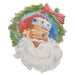 Illustration of Santa Claus winking and smiling, framed by a green wreath with a red bow. The 18" Santa Head Cut Out Wall Art 4525979 from the Treasured Moments Collection is perfect festive metal wall decor.