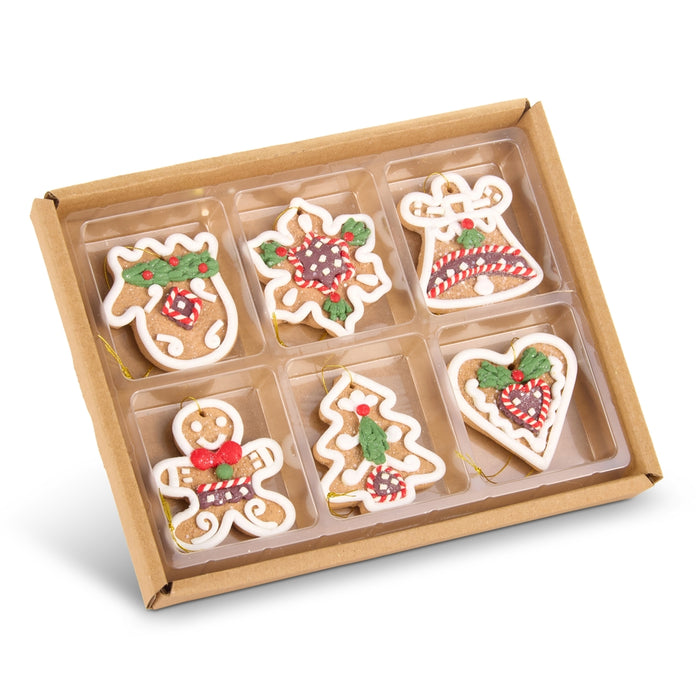 A set of 6 Mini 2″ Gingerbread Cookie Ornaments (RAZ 4616489) in a cardboard box, featuring mitten, star, bell, gingerbread person, tree, and heart shapes—all decorated with white, red, and green icing—perfect as festive ornaments or edible Christmas tree decorations.
