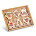 A set of 6 Mini 2″ Gingerbread Cookie Ornaments (RAZ 4616489) in a cardboard box, featuring mitten, star, bell, gingerbread person, tree, and heart shapes—all decorated with white, red, and green icing—perfect as festive ornaments or edible Christmas tree decorations.