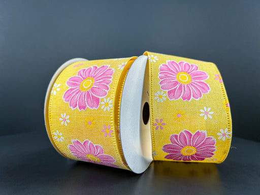 Two rolls of the 2.5"X10Y Yellow Linen/Giant Daisies Ribbon feature pink and white floral designs with prominent giant pink daisies and small white flowers on a dark gray background.