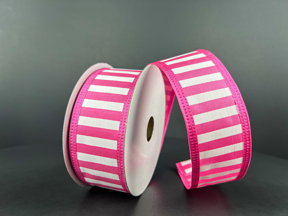 Two reels of 1.5X10Y Fuchsia Satin-White Stripes/Fuchsia Edge Ribbon 46425-09-28 stand upright against a dark background. One reel unwinds in loops, the satin stripes gleaming softly, while neatly stitched edges complete the look.