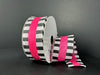 The 1.5X10Y Fuchsia Flat Breeze/Black And White Stripe Edge Ribbon (46521-09-28) displays a black and white checkerboard pattern with a vibrant fuchsia center stripe, unrolled partially against a dark background for added elegance and flair.