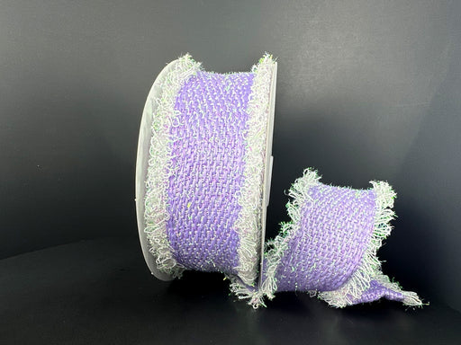 Against a black background, the 2.5X 5Y Lavender Iridescent Loopy Edge Ribbon (47509-40-30) is shown with frayed edges: one larger spool stands upright while the smaller lies beside it, displaying its soft woven texture.