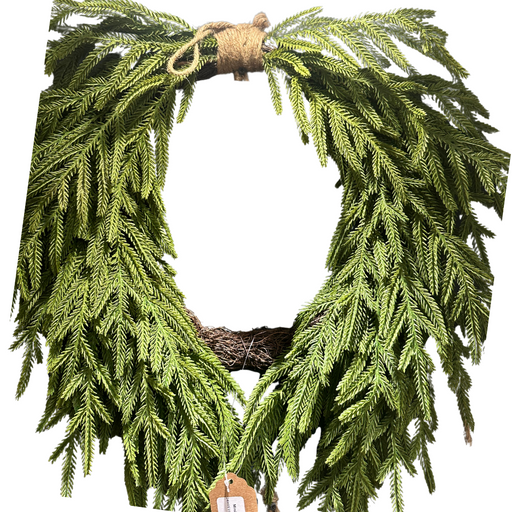 The 24 Evergreen Soft Touch Norfolk Heart Twig Wreath (510707) features fresh green pine branches in a heart shape, tied with twine at the top and finished with a brown paper tag at the bottom.
