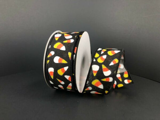 A partially unrolled 1.5x10Y black linen ribbon with glitter candy corn and orange accents (51212-09-20), displayed against a plain dark background.