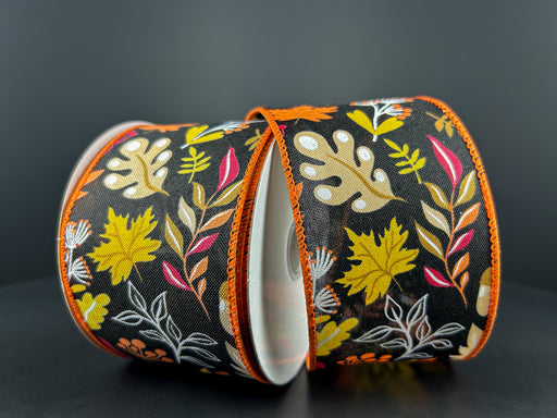 Two spools of 2.5X10Y Black Linen/Orange-Burgundy Fall Foliage Ribbon 61408-40-20 feature colorful autumn leaves on a black background, with orange-trimmed edges, sitting side by side on a dark surface.