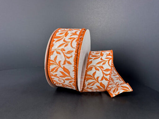 A partially unrolled 1.5X10Y Ivory Rust Orange Gold Linen Ribbon with glitter foliage swirls (61524-09-19) is displayed against a plain dark background.