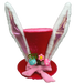The 12 by 8 Coral Decorative Velvet Bunny Hat 63772CO is an enchanting play of colors, featuring large white and pink rabbit ears, a pink ribbon, multicolored decorations including eggs and a small green plant for a festive and whimsical charm.