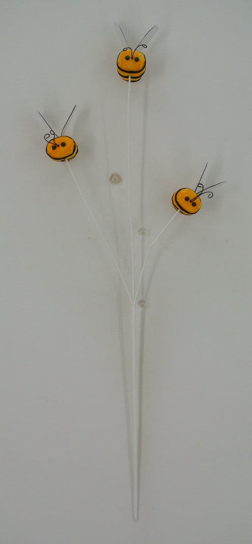 The 22 Yellow Bumble Bee Spray 64881-YEL showcases three orange and yellow bee-shaped elements on a white branch. These bumble bees, with delicate wings and antennae, create the whimsical illusion of tiny bees perched on a slender stem, set against a clean white backdrop.