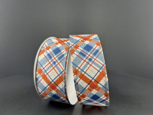 Two rolls of 1.5X10Y Cream Rust Blue Gold Argyle Ribbon (65432-09-05) featuring a cream diagonal linen pattern with rust, blue, and gold accents are displayed upright and leaning together against a plain dark background.