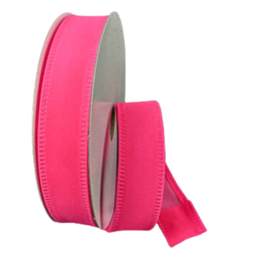 A spool of 7/8" hot pink velvet ribbon with a