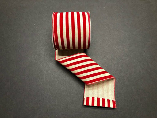 A 2.5X10Y Natural/Red Flocked Cabana Stripes Ribbon (71211-40-10) displays its bold red and natural vertical stripes and classic flocked texture, unrolled on a dark surface.