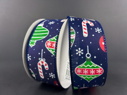 Two rolls of 1.5x10Y navy satin ribbon feature festive designs like red, green, and white hanging ornaments, candy canes, and snowflakes elegantly arranged against a plain background.