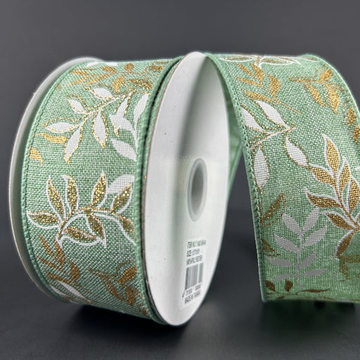 The 1.5X10Y Mint Linen/White-Gold Pressed Branches Ribbon (71492-09-06) features a mint, white, and gold pressed branches pattern. Highlighted on a dark gray background, the linen ribbon is partially unrolled to show its design.