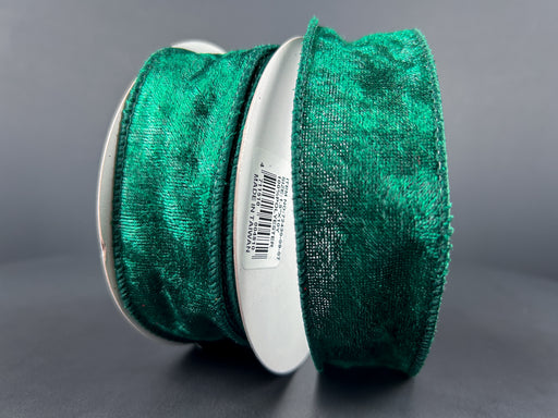 Two spools of Hunter Lush Velvet ribbon, 1.5 inches wide and 10 yards long, stand upright against a gray background. The ribbon features a soft texture and a rich emerald color, reminiscent of the wired ribbons often used for delicate crafts. One spool displays a white label with the product code "72430-09-07" in black text.