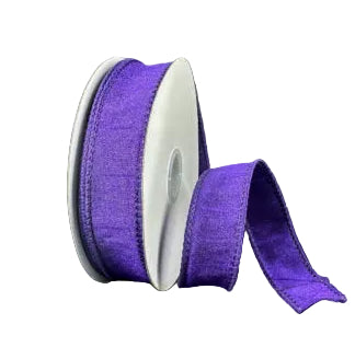 A spool of 7/8X10Y Purple Faux Dupioni Ribbon (72434-05-11) is partially unwound and displayed on a plain dark gray background, ideal for craft ribbon projects.