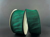 Two rolls of the 1.5"x10Y Hunter Green Faux Dupioni Ribbon stand out against a neutral gray background. The satin-finish ribbons are neatly wound on white spools, highlighting their thin black edges, and bring an elegant touch with their wired structure for easy shaping.