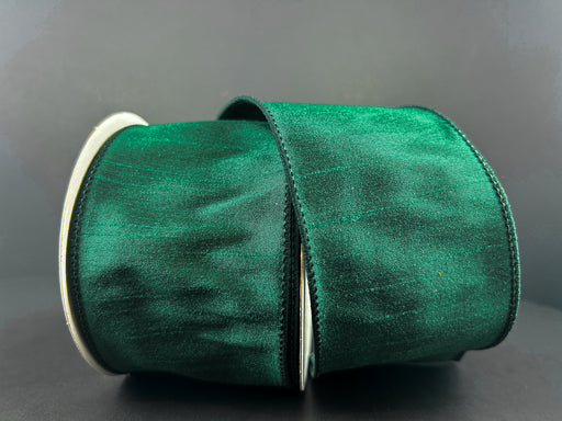A partially unfurled roll of 2.5"X10Y Hunter Green Faux Dupioni Ribbon with a glossy texture and wired edges is set against a plain gray background.