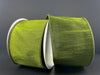 A spool of 2.5" Moss Green Faux Dupioni Wired Ribbon (72434-40-08) with a slightly textured, silk-like sheen unrolls against a dark gray background. The elegant, wide ribbon catches the light beautifully, adding a touch of sophistication to any project.