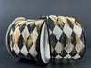 Two spools of 2.5″ x 10 yard cream canvas ribbon, featuring a black faded harlequin pattern with gold metallic accents (72437-40-20), are displayed against a dark background. The refined design of this ribbon brings an elegant touch of sophistication to any project.