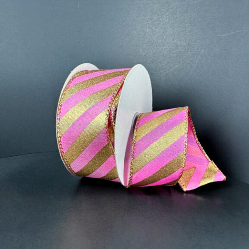 A spool of 1.5X10Y Dk Pink Satin/Gold Metallic Diagonal Stripes Ribbon (72507-09-15) is partially unrolled against a plain dark background.