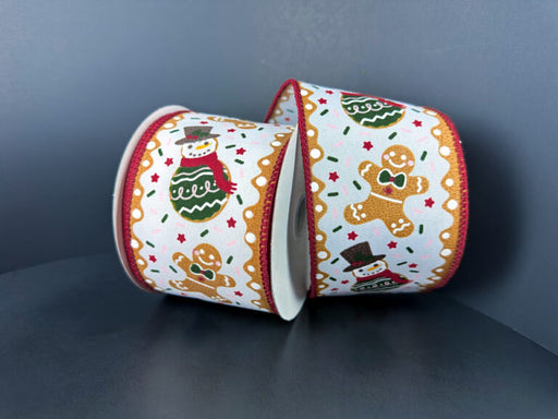 Two rolls of 2.5X10Y Red-Green Gingerbread N Cookie Cake Ribbon (72514-40-07) featuring gingerbread men, snowmen, red stars, and gold accents on a plain dark background.