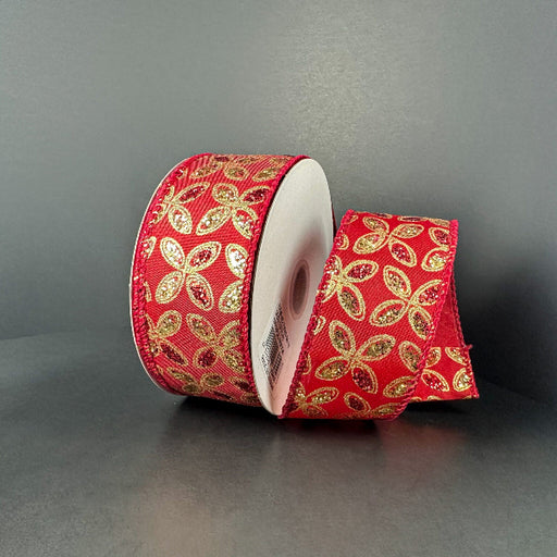 A 1.5X10Y Red Satin/Red-Gold Glitter Petals Ribbon (73509-09-13) with sparkling gold and green leaf designs is shown partially unrolled on a plain gray background.