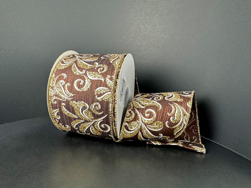 The 2.5X10Y Brown Metallic Line Satin/Gold-White Plumes Ribbon (73511-40-38) features a brown base with gold and white floral designs, adding an elegant touch to décor or gift wrapping.