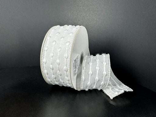 A 1.5X10Y White-Iridescent/White Snowball Weave Ribbon (73540-09-01) with a textured dot pattern is shown against a black background, featuring an unrolled section lying flat.