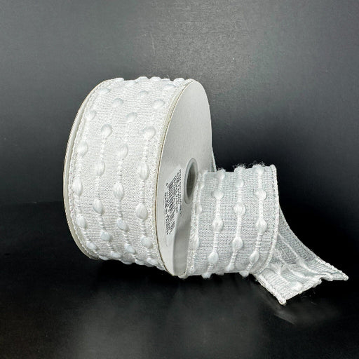 A 1.5X10Y White-Iridescent/White Snowball Weave Ribbon (73540-09-01) with a textured dot pattern is shown against a black background, featuring an unrolled section lying flat.