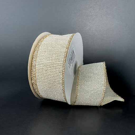 A partially unrolled spool of 1.5X10Y Ribbed Ivory-Gold Metallic Linen Ribbon (73544-09-14) with gold edges rests on a dark surface against a plain, dark background.