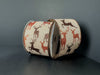 Two rolls of 2.5X10Y Natural Linen/Brown-Rust Glitter Deer Ribbon (73552-40-31) with repeating deer silhouettes in brown, black, and red on natural linen, set against a dark background.