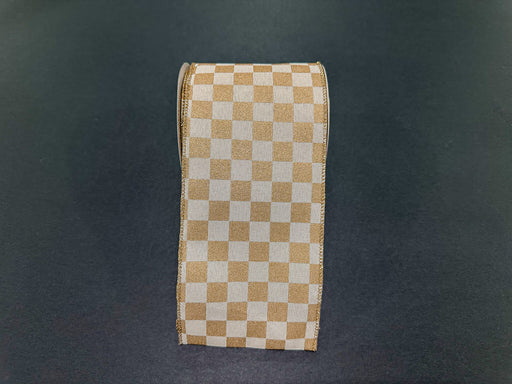 A roll of 4X10Y Cream Canvas/Gold Paint Chex Ribbon (73553-04-15) is standing upright on a dark, smooth surface.