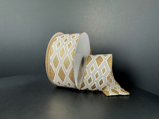 A spool of 1.5X10Y Ivory and Gold Linen/Gold Metallic Diamond Cascade Ribbon (73559-09-15) is partially unrolled, displaying its gold and white diamond pattern against a plain dark background.