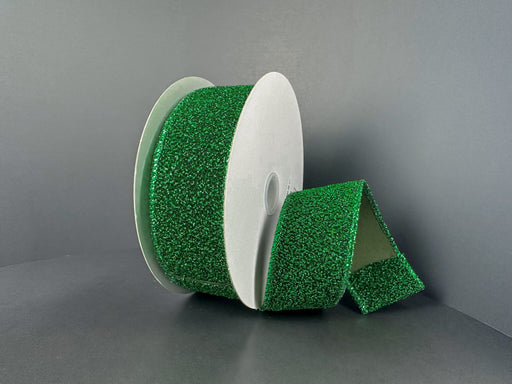 A partially unrolled 1.5X10Y Emerald-Black Fuzzy Metallic Ribbon (73566-09-17) is displayed against a plain gray background.